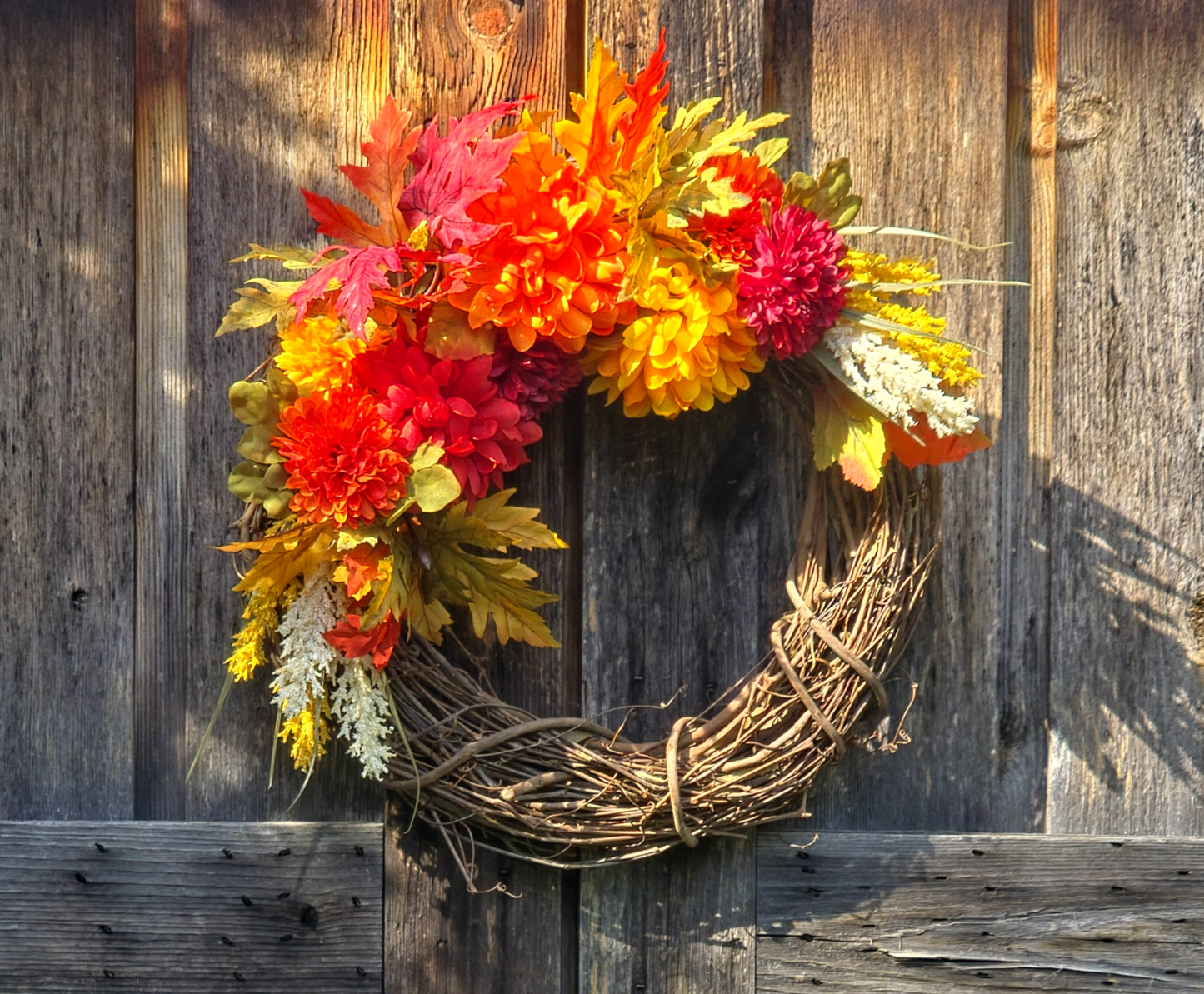 Autumn wreath with colorful leaves on a wooden background